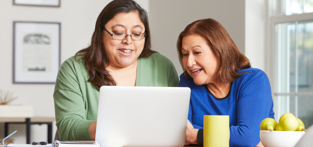 Two women using a laptop together.