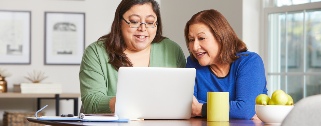 Two women using a laptop together