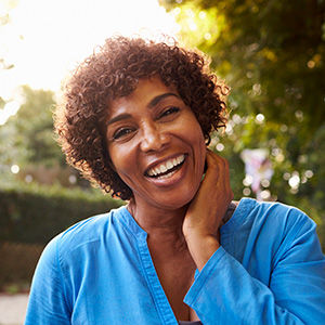 African American woman with short hair wearing a blue shirt