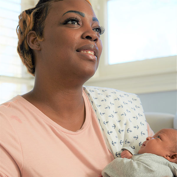 Diontre holding her newborn baby