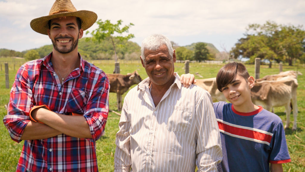 Father and sons posing on a farm