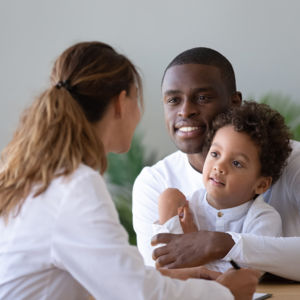 Man holding boy with doctor