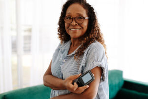 Woman checking her blood sugar levels with continuous glucose monitoring